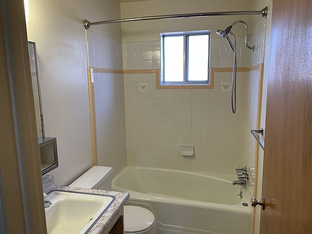 Bathroom is clean with tile tub surround