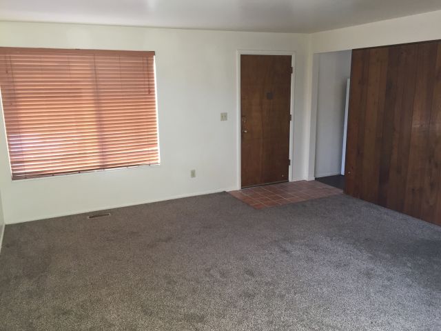 Living Room with large windows & tile in front entry