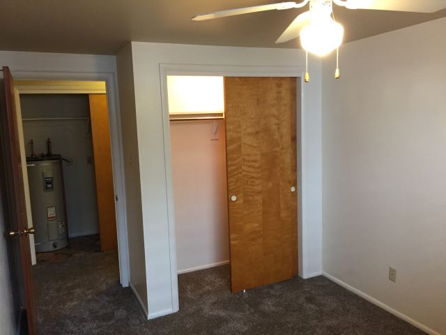 Bedroom #2 has large lighted closet, ceiling fan, window blind and drapes